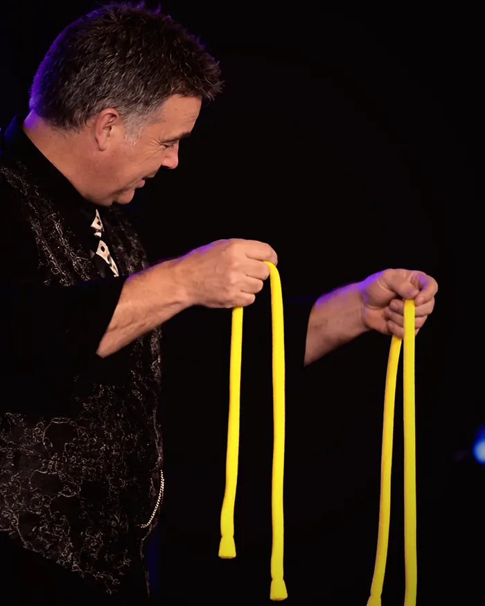 Jonathon performing a rope routine on a lit stage during a cabaret show